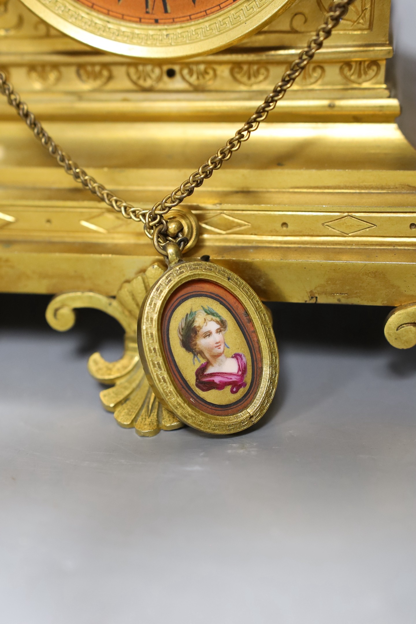 A late 19th century French Etruscan revival ormolu and porcelain mounted three piece clock garniture, 40cm